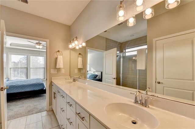 bathroom featuring tile patterned flooring, vanity, ceiling fan, and a shower with door