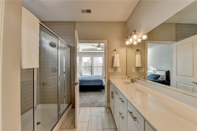 bathroom featuring tile patterned floors, ceiling fan, vanity, and a shower with shower door