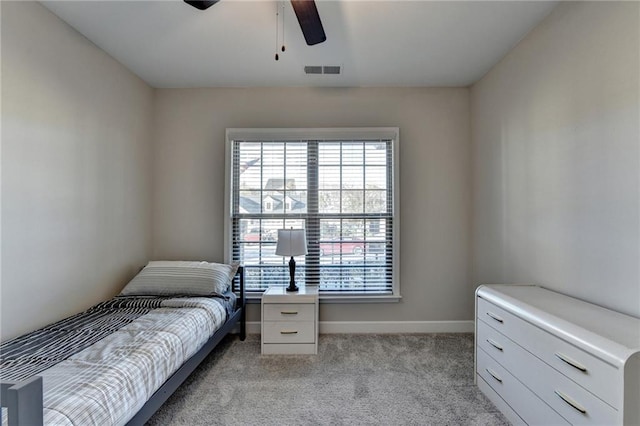 bedroom featuring ceiling fan and light carpet