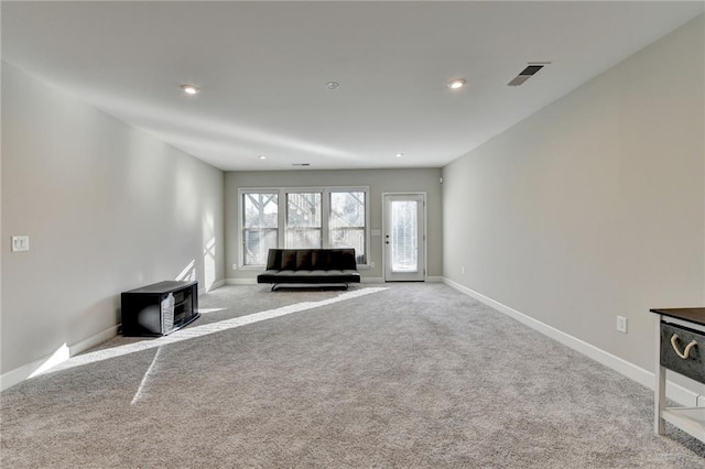 unfurnished living room featuring light colored carpet