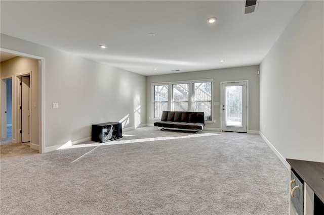 unfurnished living room featuring light carpet