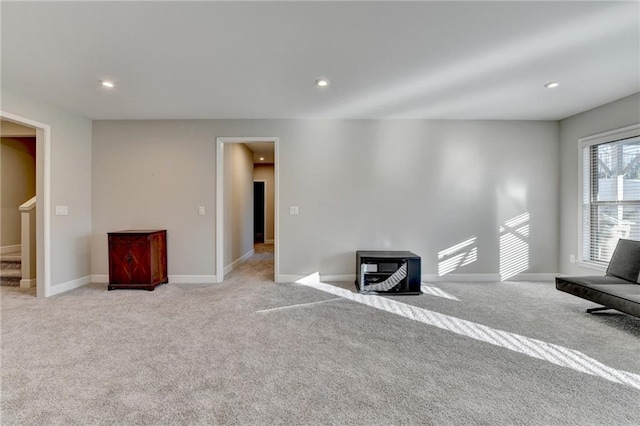 unfurnished living room featuring light colored carpet