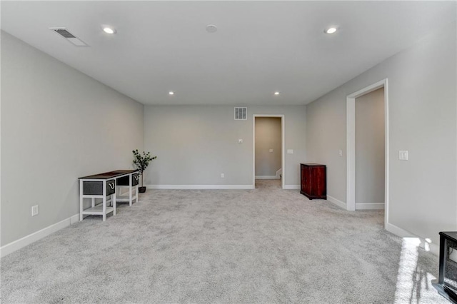 spare room featuring light colored carpet