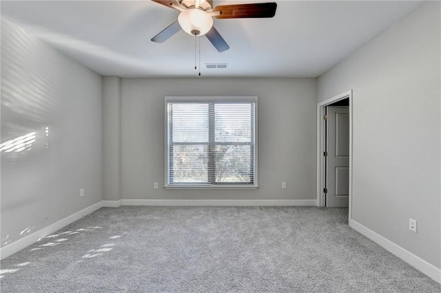 carpeted spare room with ceiling fan