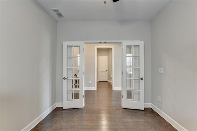 spare room with french doors and dark wood-type flooring