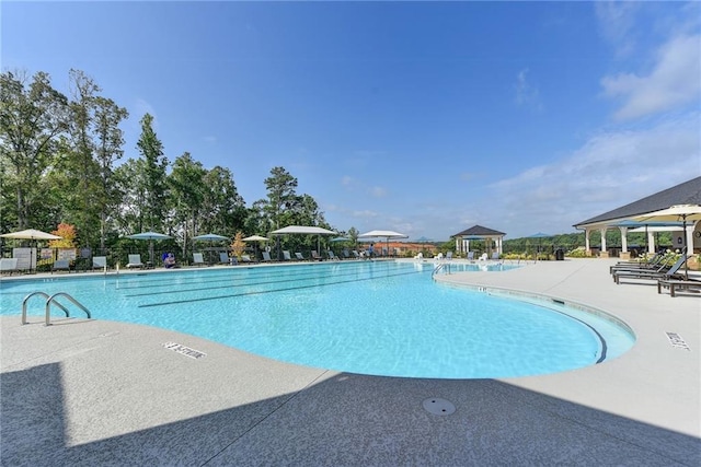 view of swimming pool with a gazebo and a patio area