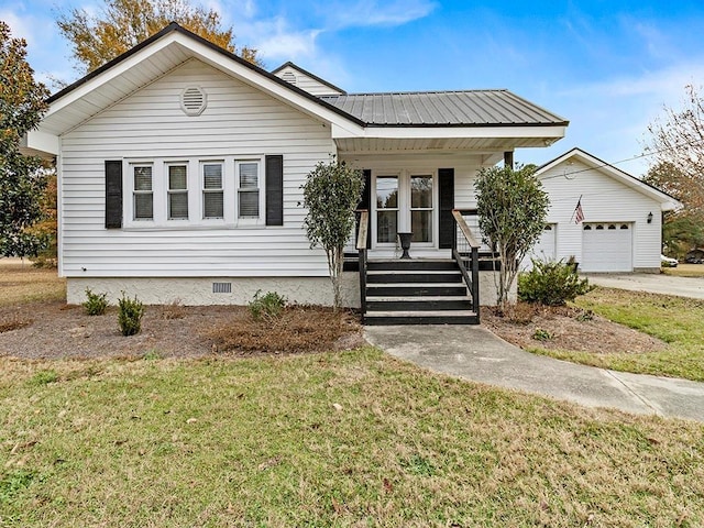 bungalow-style house featuring covered porch and a front yard