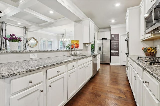 244 Lotus Cir, Mcdonough, GA 30252 - kitchen with a sink, white cabinets, ornamental molding, and stainless steel appliances