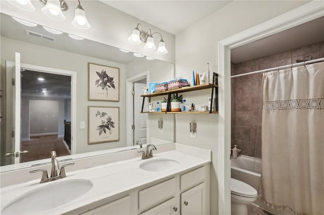 244 Lotus Cir, Mcdonough, GA 30252 - bathroom featuring shower / bath combo with shower curtain, toilet, visible vents, and a sink