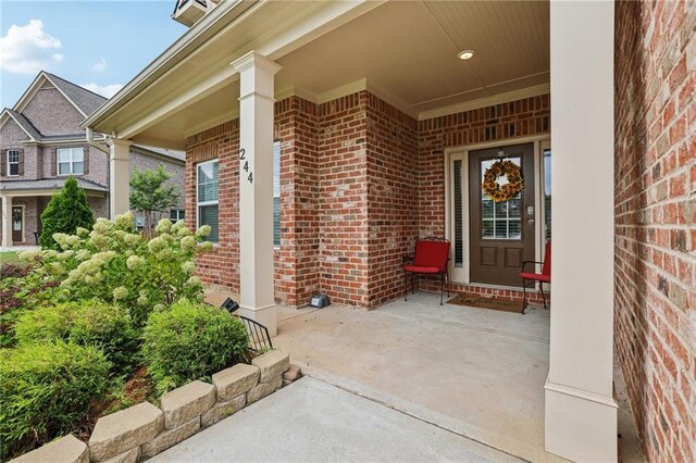 244 Lotus Cir, Mcdonough, GA 30252 - view of exterior entry with brick siding and a porch
