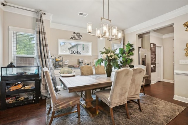 244 Lotus Cir, Mcdonough, GA 30252 - dining room featuring visible vents, baseboards, ornamental molding, and dark wood-style flooring