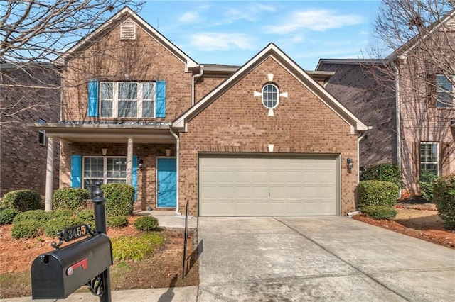 traditional-style house with concrete driveway, brick siding, and a garage