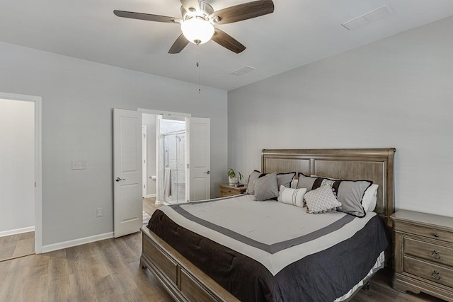 bedroom with visible vents, wood finished floors, baseboards, and ceiling fan