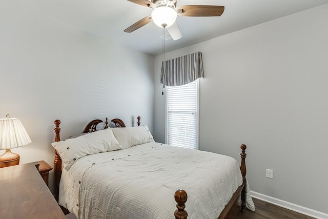 bedroom with dark wood-style flooring, baseboards, and ceiling fan
