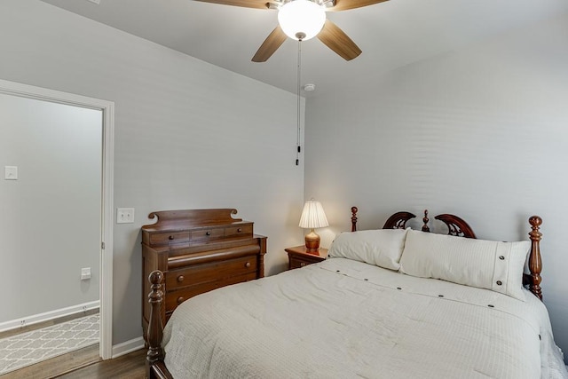 bedroom featuring wood finished floors, baseboards, and ceiling fan