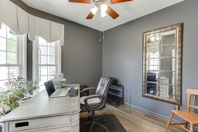 home office with ceiling fan, baseboards, and wood finished floors