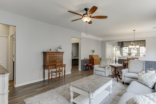 living room with baseboards, wood finished floors, and ceiling fan with notable chandelier