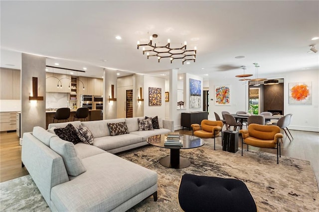 living room featuring an inviting chandelier and light hardwood / wood-style flooring