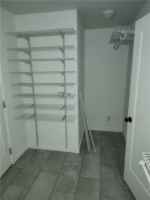 spacious closet featuring tile patterned flooring