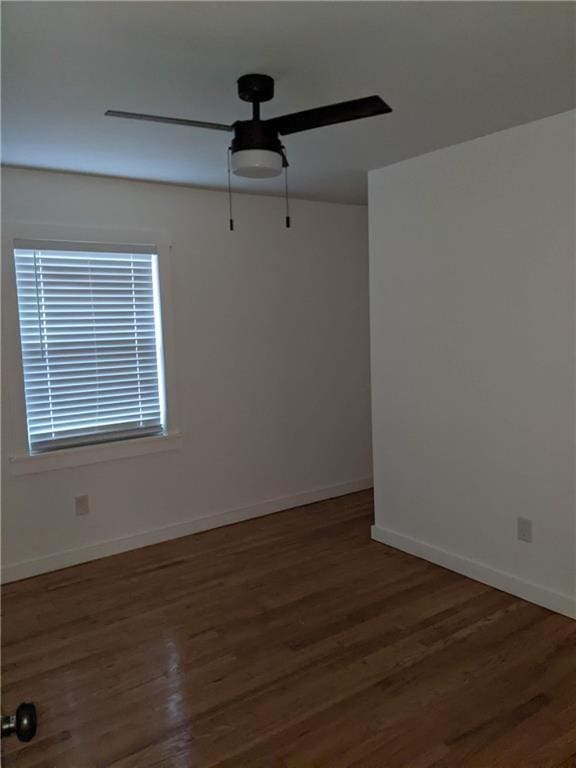 unfurnished room featuring ceiling fan, baseboards, and wood finished floors