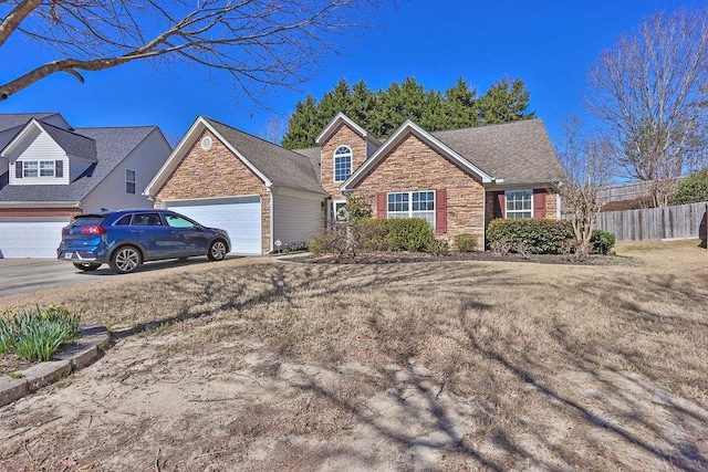 ranch-style home featuring a garage, stone siding, fence, and driveway