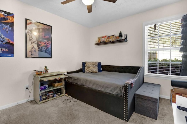 carpeted bedroom featuring a ceiling fan and baseboards