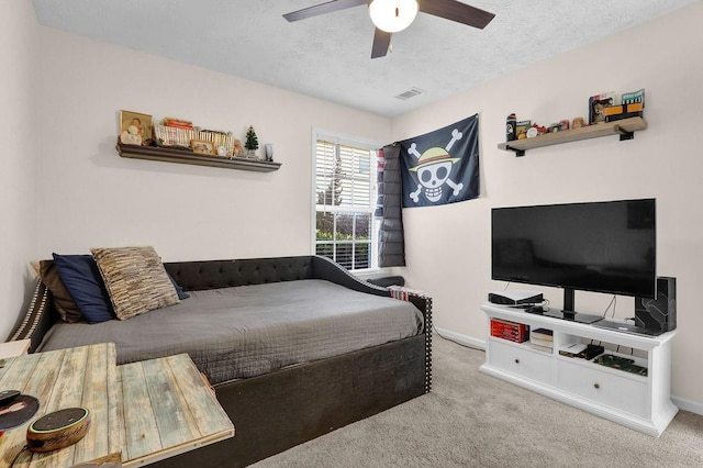 bedroom featuring a textured ceiling, carpet, visible vents, and baseboards