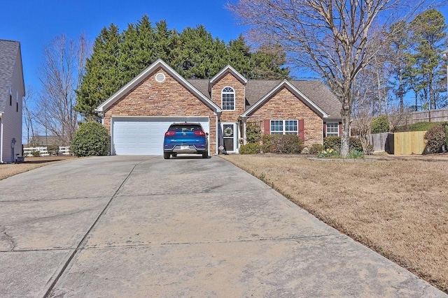 view of front facade featuring roof with shingles, fence, a garage, stone siding, and driveway