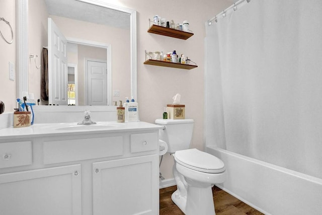 bathroom featuring shower / bath combo with shower curtain, vanity, toilet, and wood finished floors