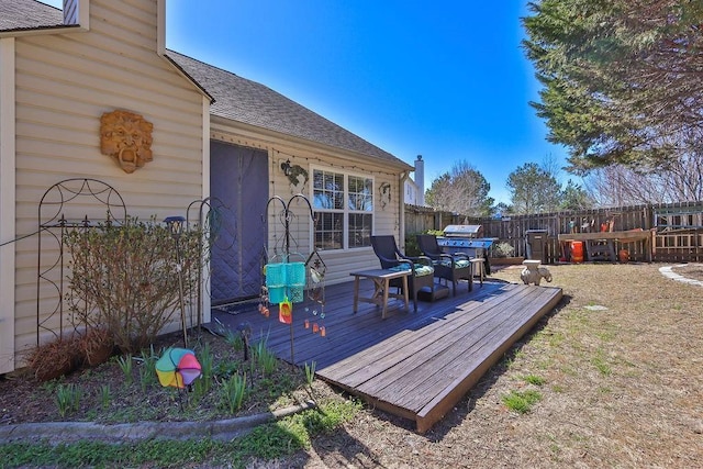 wooden terrace featuring fence