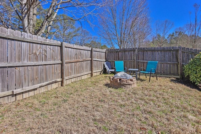 view of yard with an outdoor fire pit and a fenced backyard