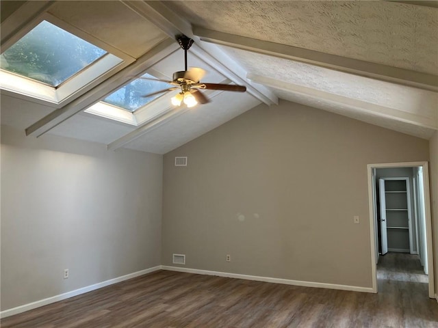 bonus room featuring lofted ceiling with skylight, dark wood-type flooring, and ceiling fan