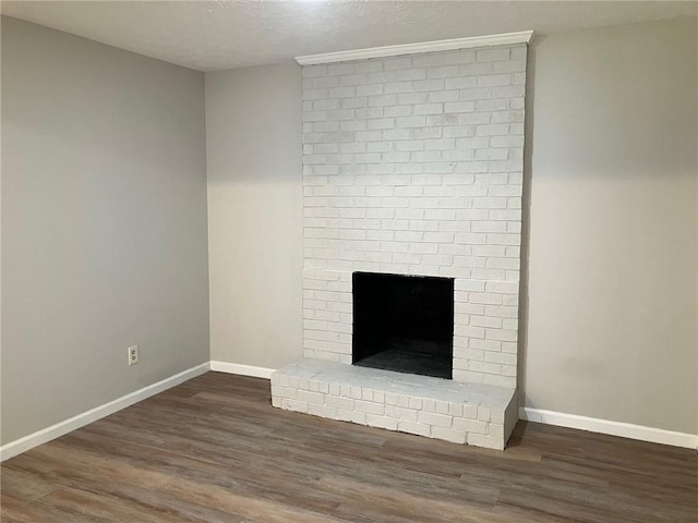 details with wood-type flooring, a brick fireplace, and a textured ceiling