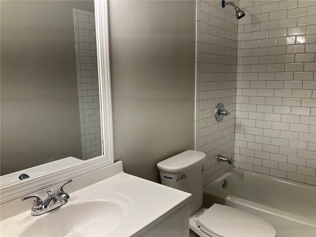 full bathroom featuring tiled shower / bath combo, vanity, and toilet