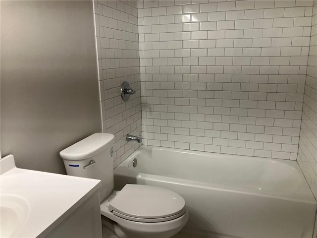 full bathroom featuring tiled shower / bath combo, vanity, and toilet