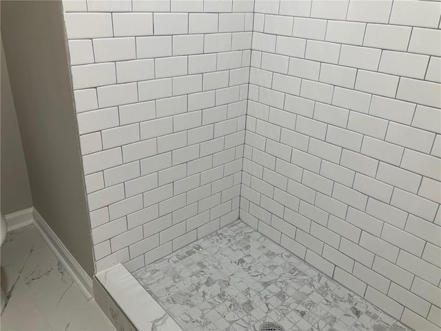 bathroom featuring a tile shower