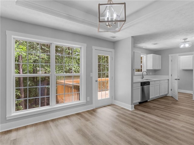 220 Sugar Hill Ct, Jackson, GA 30233 - kitchen featuring stainless steel dishwasher, baseboards, light countertops, and a chandelier