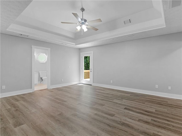 220 Sugar Hill Ct, Jackson, GA 30233 - unfurnished room with a raised ceiling, ceiling fan, baseboards, and wood finished floors