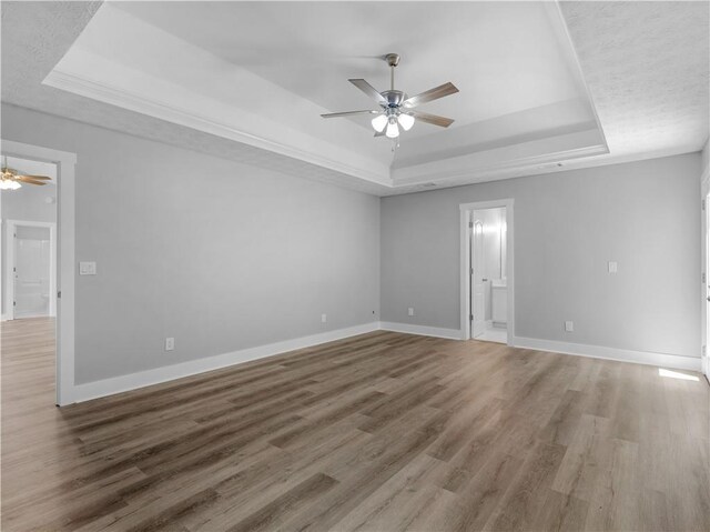 220 Sugar Hill Ct, Jackson, GA 30233 - empty room with a raised ceiling, a ceiling fan, light wood-type flooring, and baseboards