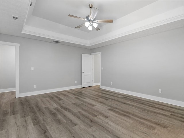 220 Sugar Hill Ct, Jackson, GA 30233 - empty room featuring a tray ceiling, ceiling fan, and wood finished floors