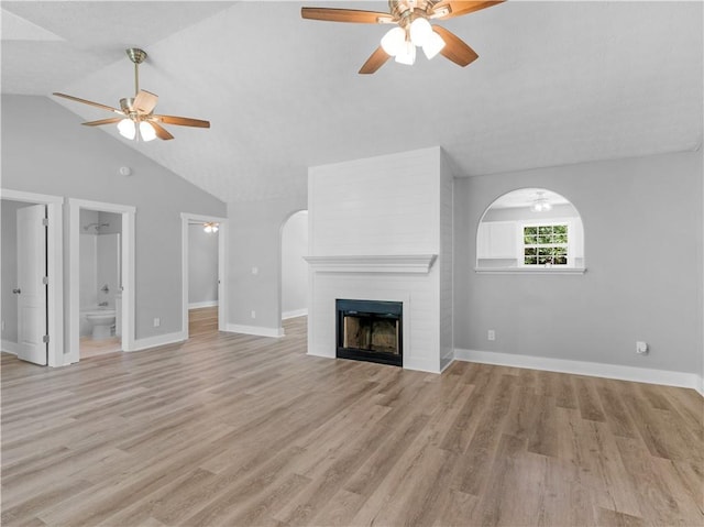 220 Sugar Hill Ct, Jackson, GA 30233 - unfurnished living room with a ceiling fan, a fireplace, light wood-type flooring, baseboards, and lofted ceiling