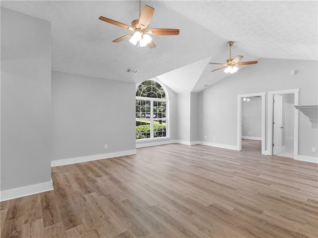 220 Sugar Hill Ct, Jackson, GA 30233 - unfurnished living room with ceiling fan, light wood-style flooring, vaulted ceiling, baseboards, and a textured ceiling
