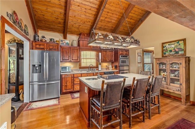 259 Eagle Chase Cir, Dillard, GA 30537 - kitchen featuring stainless steel appliances, a wooden ceiling with exposed beams, light wood finished floors, a center island with sink, and brown cabinetry