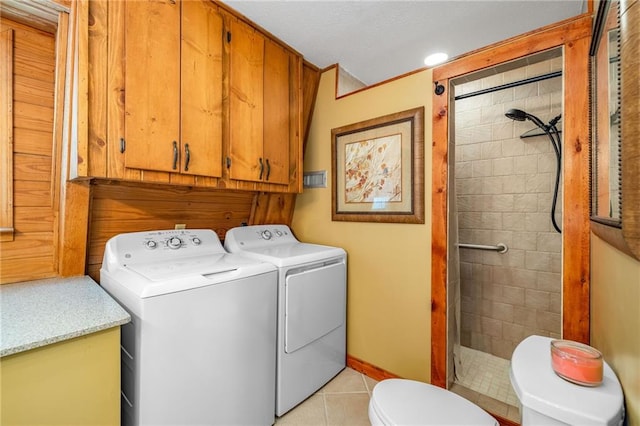 259 Eagle Chase Cir, Dillard, GA 30537 - laundry area featuring washer and clothes dryer, light tile patterned flooring, and cabinet space