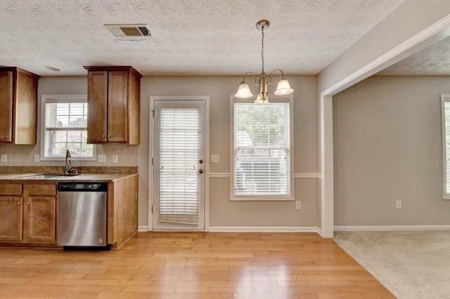 kitchen with hanging light fixtures, stainless steel dishwasher, a notable chandelier, and light wood-type flooring