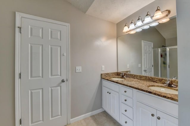 bathroom with tile patterned floors, a textured ceiling, an enclosed shower, vaulted ceiling, and vanity