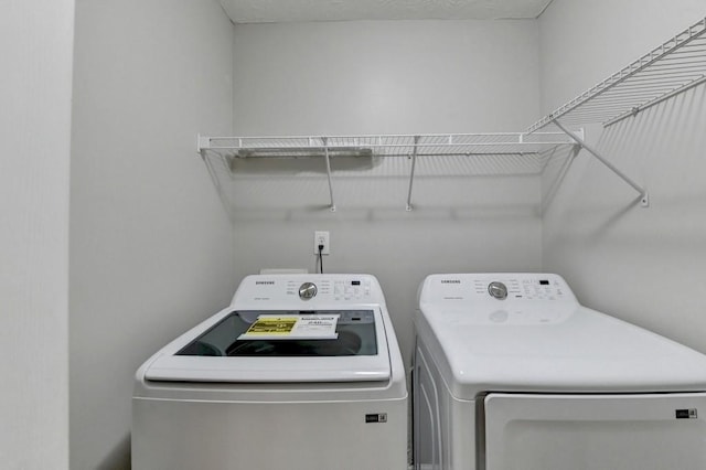 laundry area featuring washing machine and clothes dryer