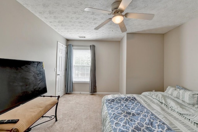 bedroom with light carpet, a textured ceiling, and ceiling fan