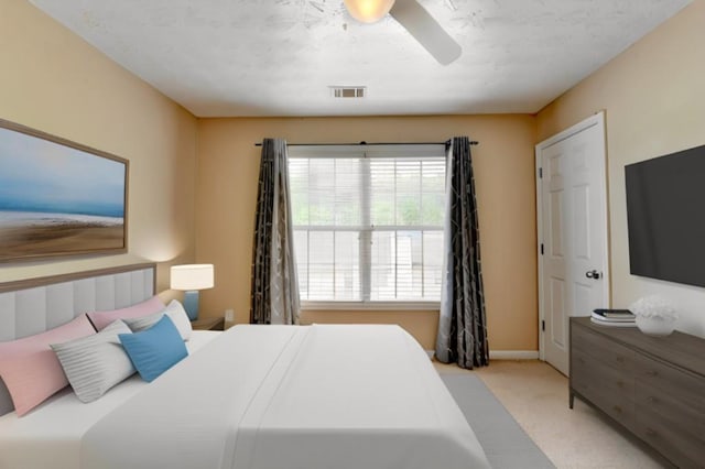 bedroom with ceiling fan and light colored carpet