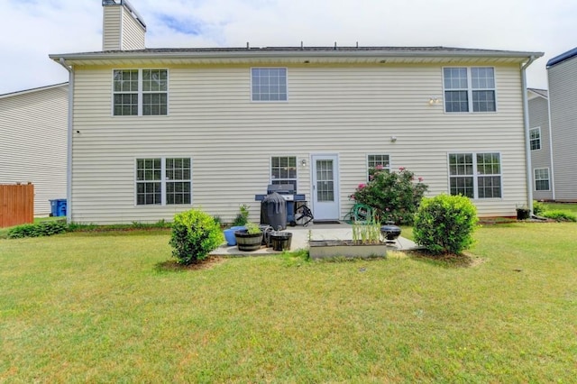 back of property with a patio and a lawn